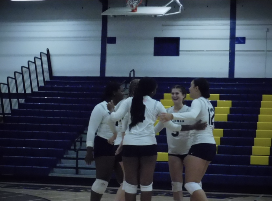 Lady Bruin's Volleyball Varsity squad spreading smiles across the court after scoring a hard fought point. Final score (1-3)